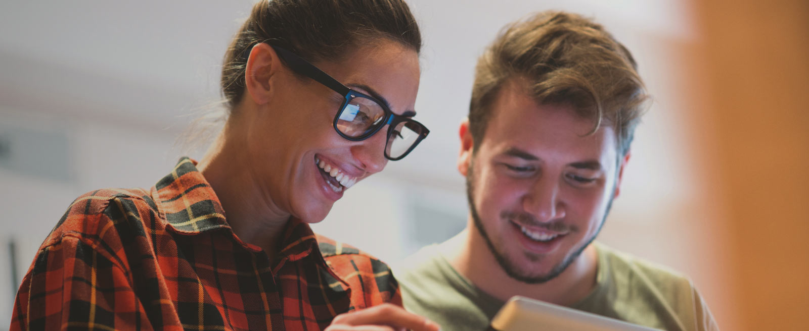 Woman and man looking at tablet