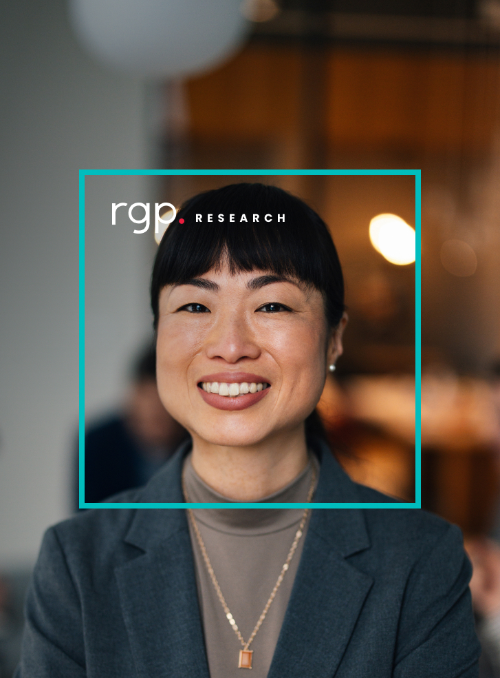 A businesswoman beams to the camera